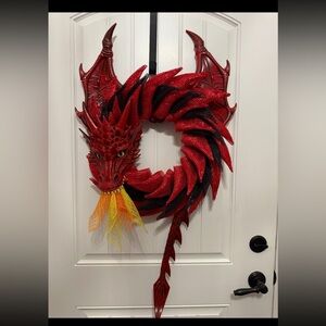 Scary burlap wreath red dragon with fire coming out of his mouth.